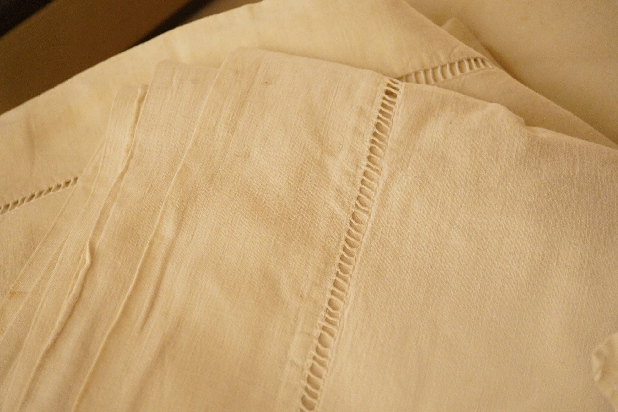 A quantity of French provincial thick linen sheets, with mostly embroidered or monogrammed turn backs (17). Condition - good